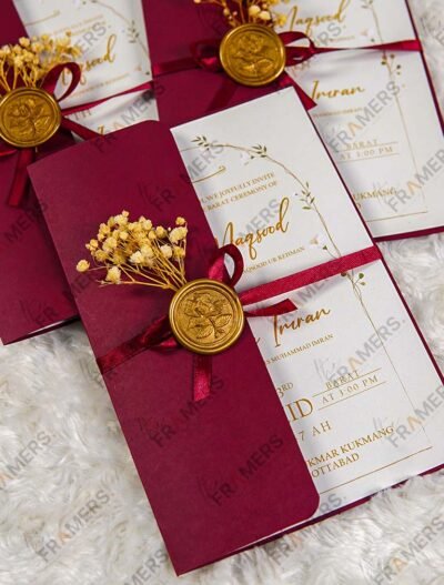 Burgundy gatefold wedding invitations with wax seals and dried baby's breath