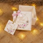 Open tray Baat Paaki bid boxes with pink floral tag