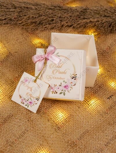 Open tray Baat Paaki bid boxes with pink floral tag