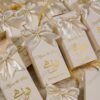 Close-up large cream satin bow on vertical bid boxes