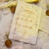 White wedding invitation with baby's breath and gold wax seal styling